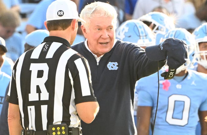 North Carolina coach Mack Brown and the referee during his team's game against Charlotte at Kenan Memorial Stadium.